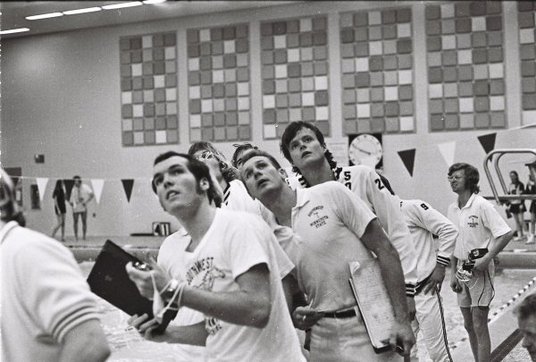 2026-04-01-coach-and-swimmers-looking-at-clock.jpg